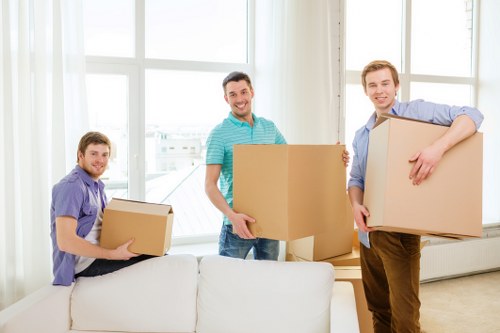 Movers handling furniture in a Kilburn flat building