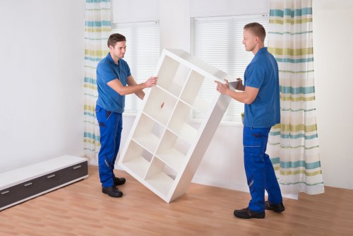 Movers handling sofa and tables during a Kilburn relocation